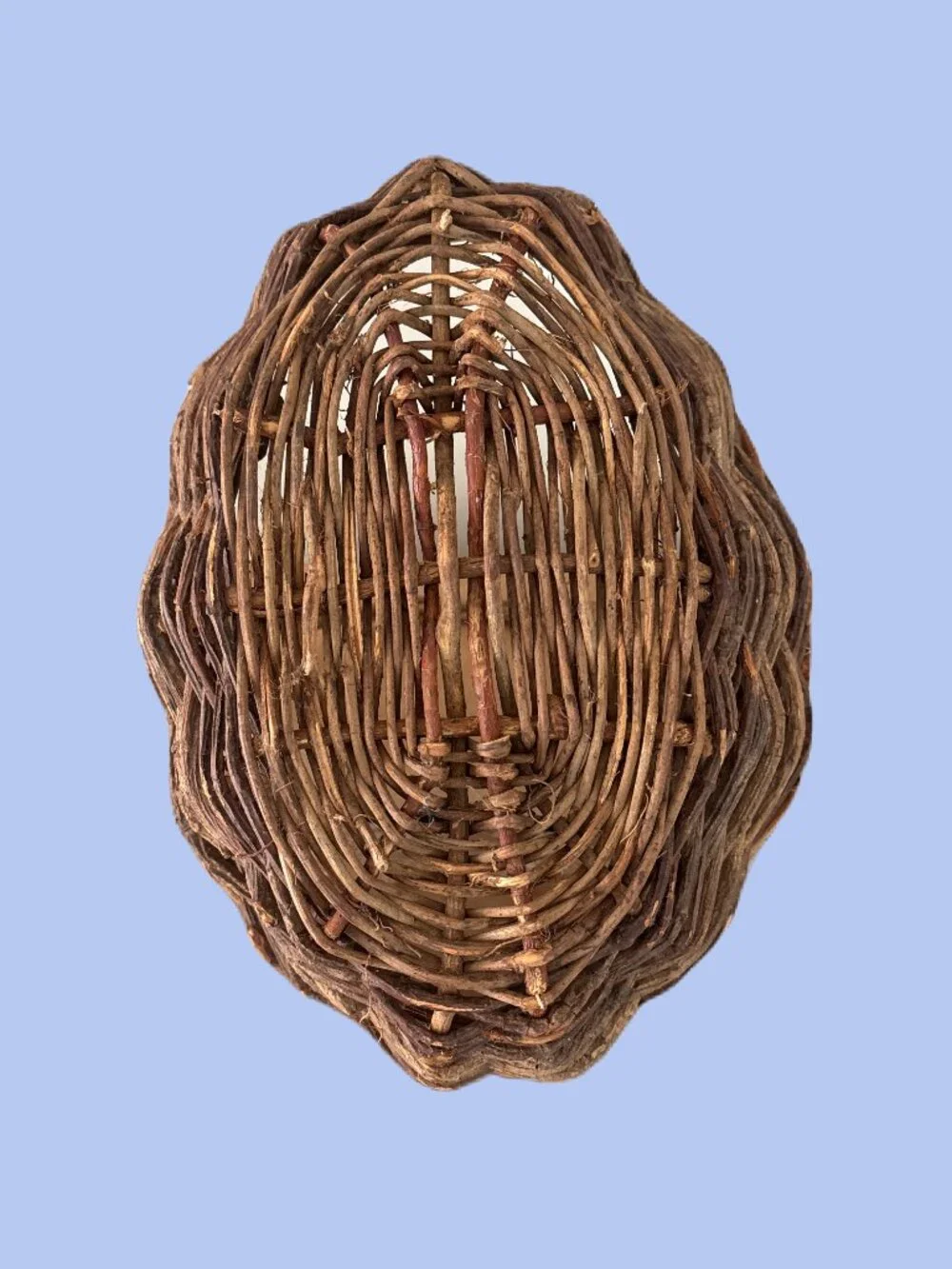 Handwoven vintage twig gathering basket with handle.